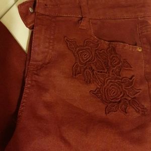 Maroon skinny jeans with flowers